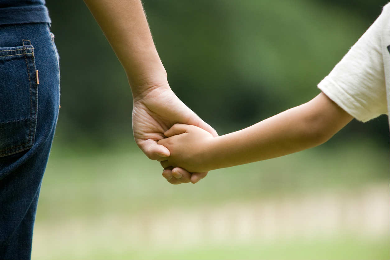parent holding child's hand