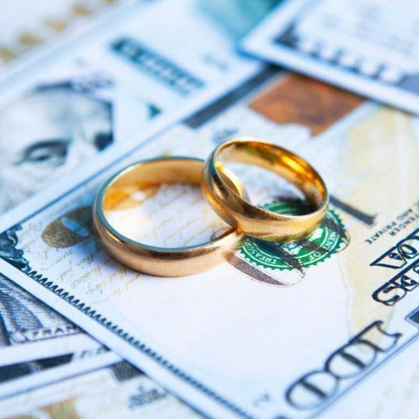 wedding rings on top of money