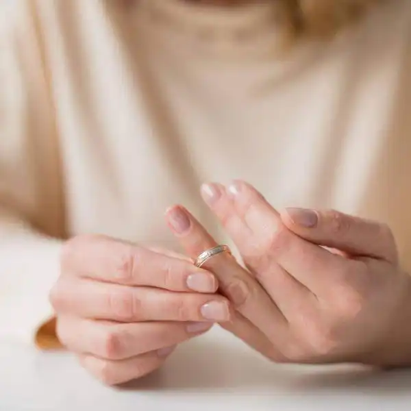 woman taking off wedding band